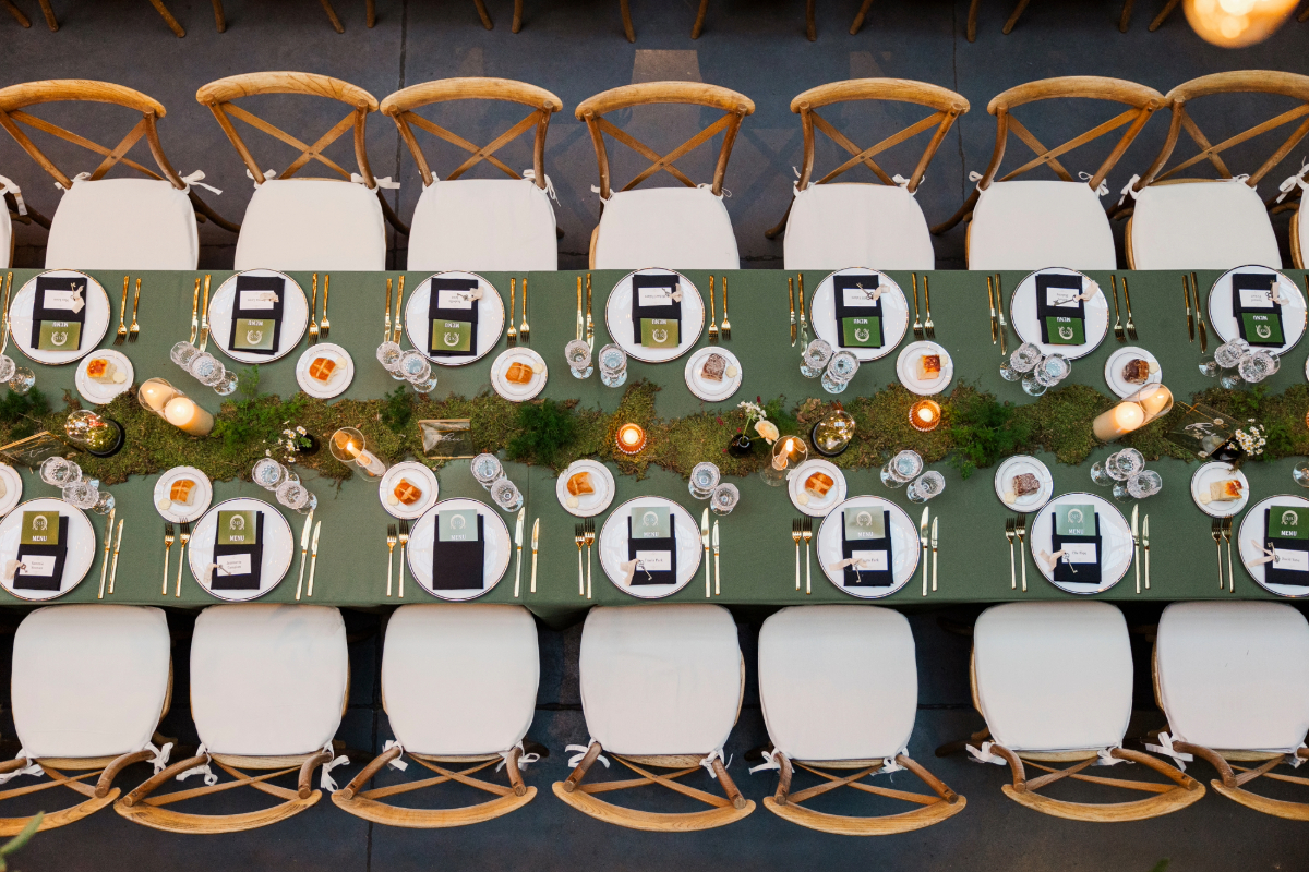 long table with chairs and green runner